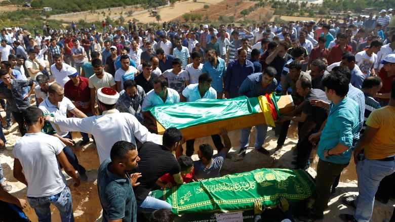 Family members and friends carry coffins of victims of suicide bombing at a wedding celebration during a funeral ceremony in the southern Turkish city of Gaziantep Turkey