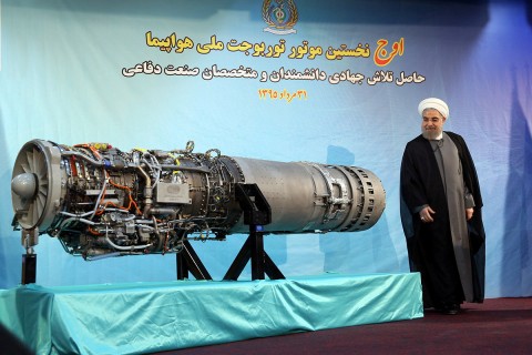 Iranian President Hassan Rouhani stands next to an Iranian-made fighter jet engine in Tehran on Sunday