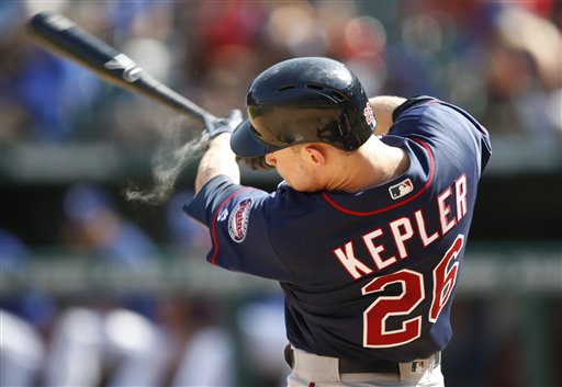 Minnesota Twins&#039 Max Kepler follows through and reaches first on a throwing error by Texas Rangers second baseman Rougned Odor during the eighth inning of a baseball game Sunday