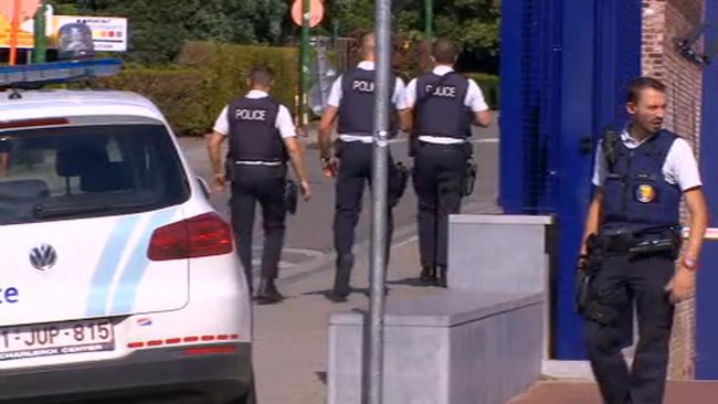 Police secure the area near to the scene of a machete attack on two police officers Saturday Aug. 6 2016 outside the police station in Charleroi Belgium. The attack happened Saturday at a checkpoint providing an additional layer of security outside the