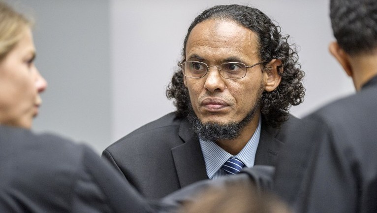 Alleged Al Qaeda-linked Islamist leader Ahmad Al Faqi Al Mahdi center looks on during an appearance at the International Criminal Court in The Hague