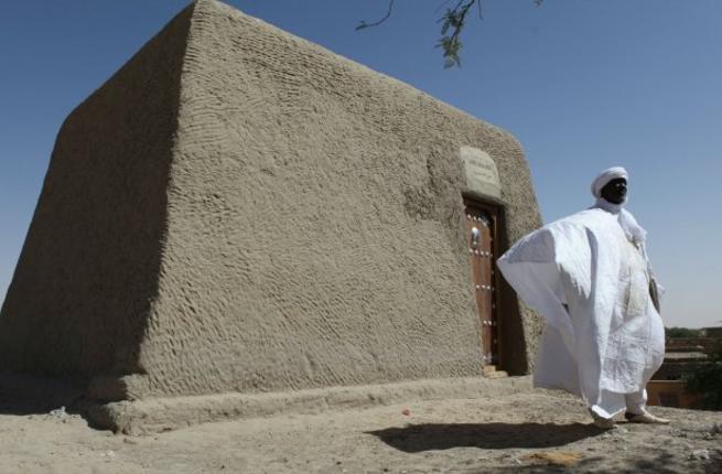 Sane Chirfi representing the family that looks after the Alpha Moya mausoleum poses in front of the recovered monument