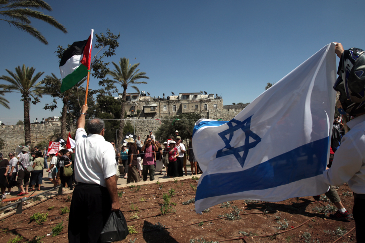 Israeli and Palestinian peace activists marching outside Jerusalem's Old City