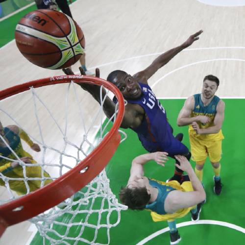 Kevin Durant center shoots over Australia's Cameron Bairstow left and Matthew Dellavedova right during a basketball game at the 2016 Summer Olympics in Rio de Janeiro Brazil Wednesday Aug. 10 2016. (AP