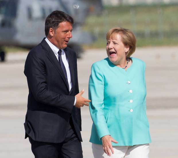 Italian Premier Matteo Renzi left welcomes German Chancellor Angela Merkel at Capodichino international airport Naples