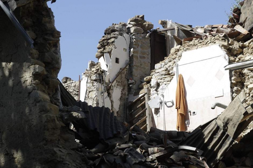 A bathrobe hangs from a wall of a collapsed house in Villa San Lorenzo a Flaviano near Amatrice central Italy Thursday Aug. 25 2016