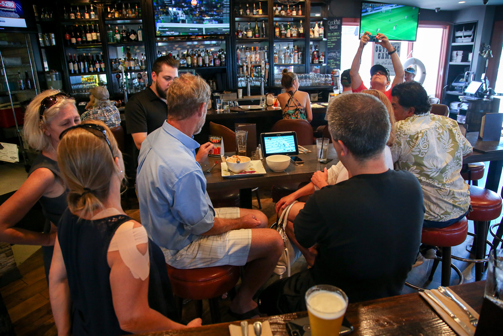 Local fans resort to watching the women’s water polo semi-final on a tablet Wednesday because NBC kept shifting to other Olympic events