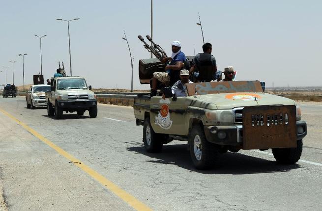 Forces loyal to Libya's UN-backed unity government patrol the entrance of Sirte as they advance to recapture the city from the Daesh group