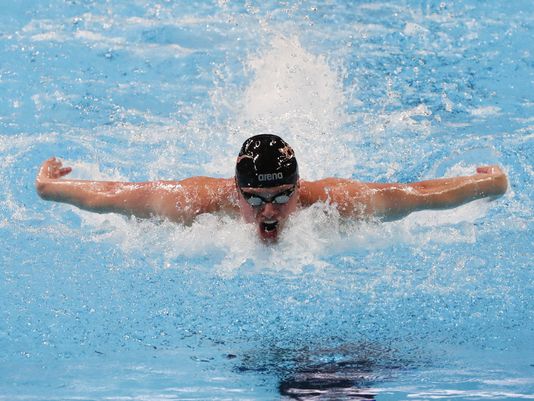 Jack Conger during the men's 100 butterfly preliminary heats July 1