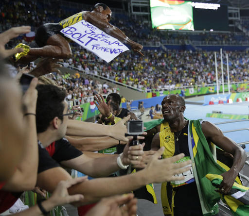 Jamaica's Usain Bolt greets fans as he celebrates winning gold in the men's 4 x 100-meter relay final