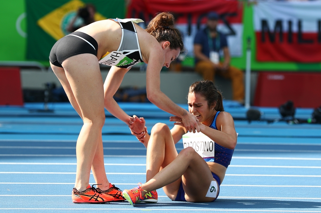 RIO DE JANEIRO BRAZIL- AUGUST 16 Abbey D'Agostino of the United States is assisted by Nikki Hamblin of New Zealand after a collision during the Women's 5000m Round 1- Heat 2 on Day 11 of the Rio 2016 Olympic Games at the Olympic Stadium