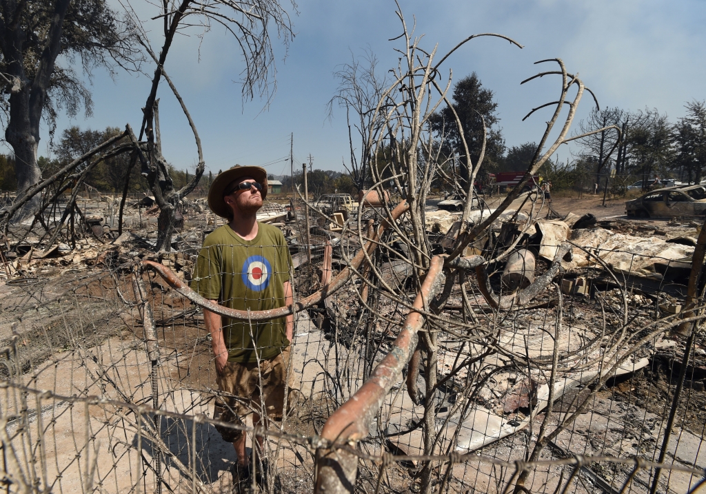 James Mc Cauley looks over the burned-out remains of his residence in the town of Lower Lake Calif. Monday Aug. 15 2016