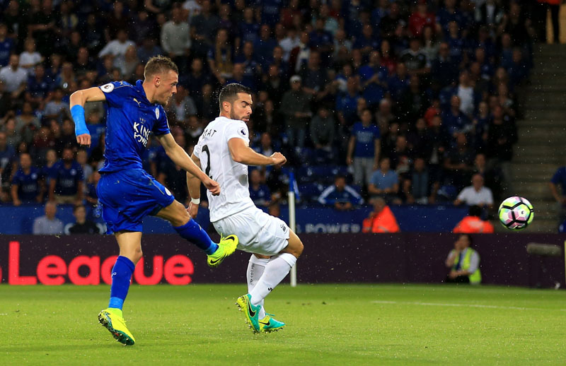 Leicester City's Jamie Vardy left scores his side's first goal of the game during their Premier League soccer match against Swansea City at the King Power Stadium Leicester England on Saturday