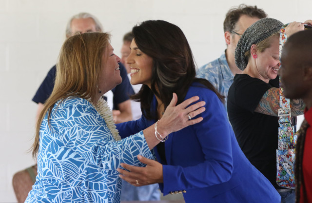 Jane Sanders embraces Congresswoman Tulsi Gabbard at the Tommy Kakesako building. 20 march 2016