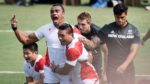 Japan celebrate their win as Regan Were and captain Scott Curry stand dejected