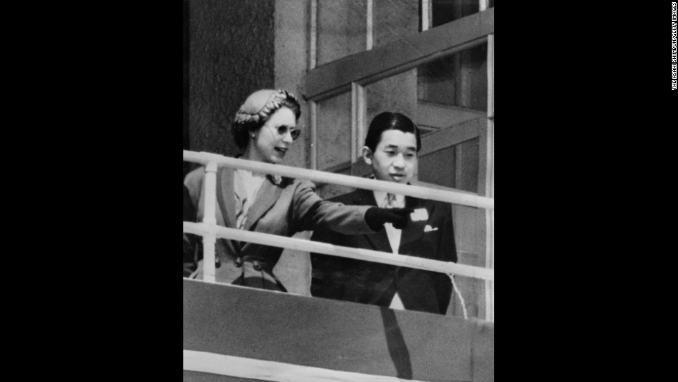 Queen Elizabeth II and Akihito are seen in the royal box at the Epsom Downs Racecourse