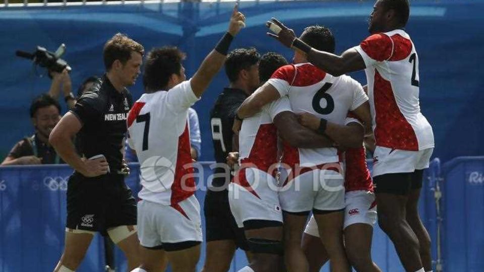 Japan sevens players celebrate their shock 14–12 win over New Zealand