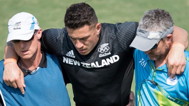 Sonny Bill Williams is helped from the field after being injured during day one of the men's rugby sevens at the Rio