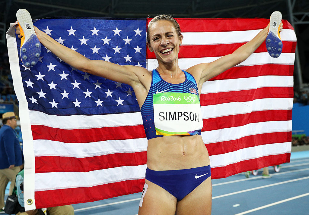 Jennifer Simpson of the United States celebrates with the American flag after winning the bronze medal in the Women's 1500m Final on Day 11 of the Rio 2016 Olympic Games at the Olympic Stadium