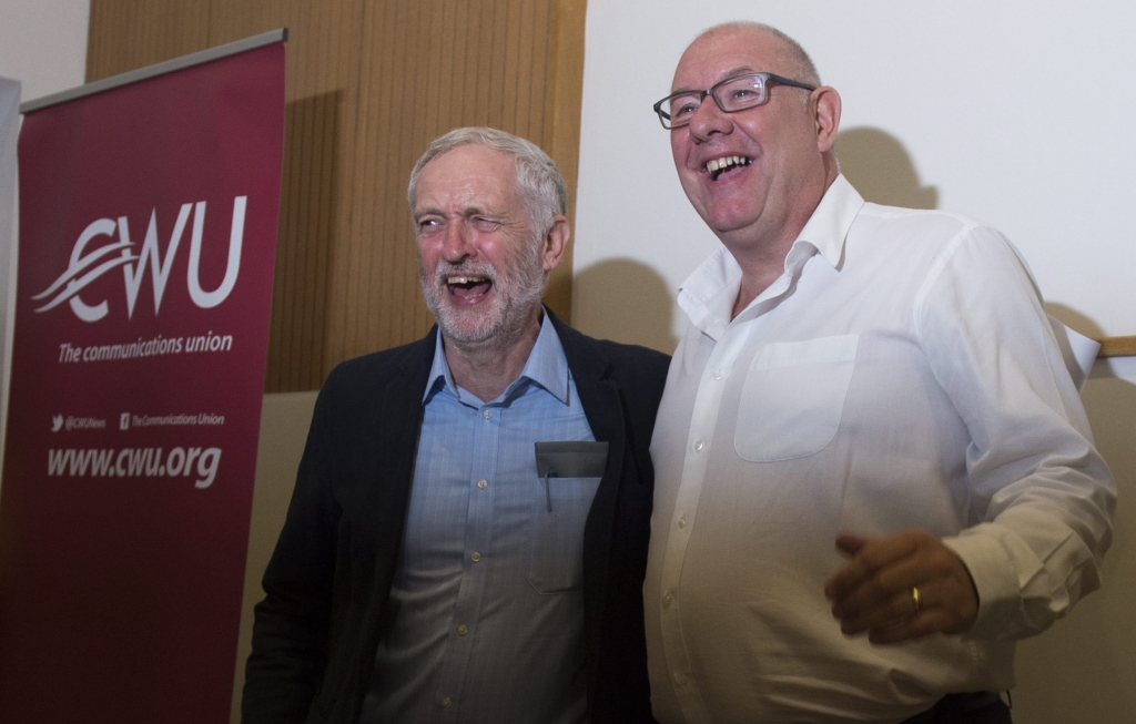 Jeremy Corbyn jokes with CWU leader Dave Ward. The union has thrown its weight behind Mr Corbyn’s campaign to remain Labour leader Will Oliver  EPA