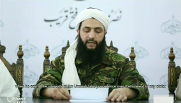 Mohammed al Jolani of Jabhat al Nusra reading a prepared statement announcing Nusra's official split from Al Qaeda