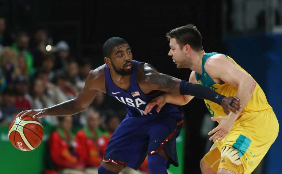 RIO DE JANEIRO BRAZIL- AUGUST 10 Kyrie Irving #10 of United States handles the ball against Matthew Dellavedova #8 of Australia during the Men's Preliminary Round Group A game between Australia and the United States on Day 5 of the Rio 2016 Olympic Ga