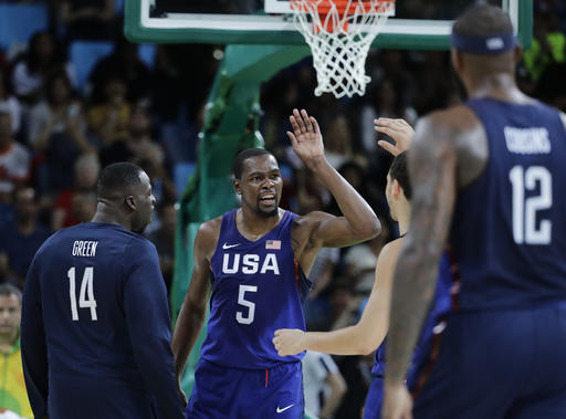 United States Kevin Durant celebrates with teammates United States Draymond Green and others after a steal and dunk against Serbia during the men's gold medal basketball game at the 2016 Summer Olympics