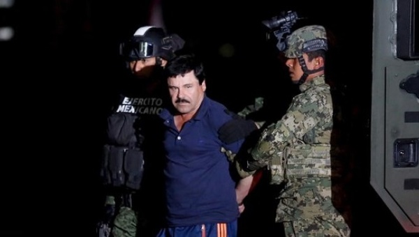 Joaquin'El Chapo Guzman is escorted by soldiers during a presentation in Mexico City Jan. 8 2016