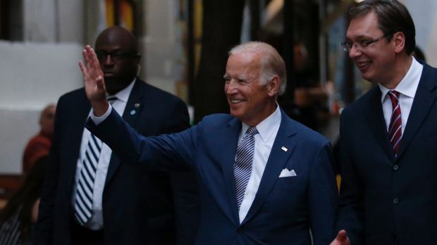 US Vice President Joe Biden centre waves to onlookers with Serbian Prime Minister Aleksandar Vucic right as they