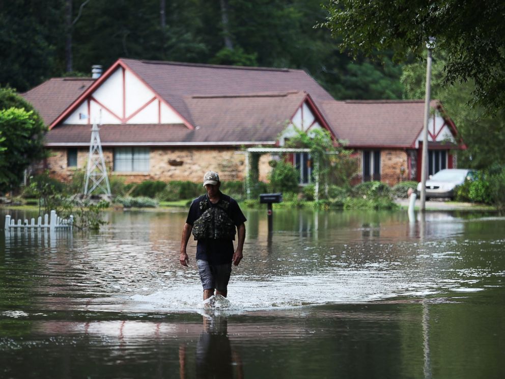 Joe Raedle  Getty Images Ryan Evans walks along a flooded road Aug. 15 2016 in Baton Rouge Louisiana