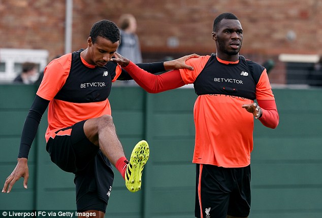 Joel Matip and Christian Benteke stretch together at Melwood on Friday