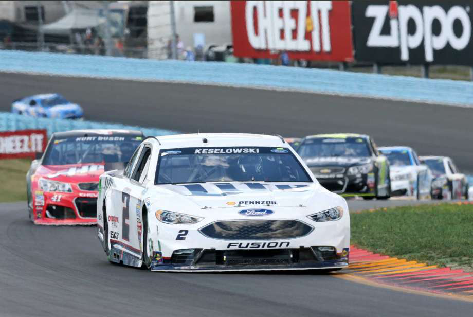 Brad Keselowski leads a group through the esses during a NASCAR Sprint Cup. He and Kyle Busch went wide on a turn later and Denny Hamlin overtook them