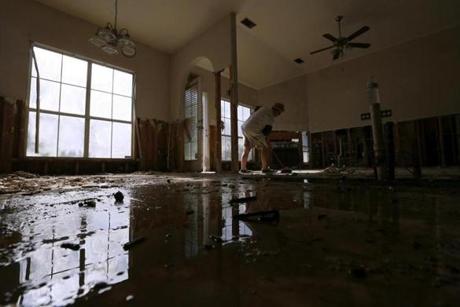 Scharlett Gaddy helps clean a friend's flood damaged home at the South Point subdivision in Denham Springs Louisiana U.S