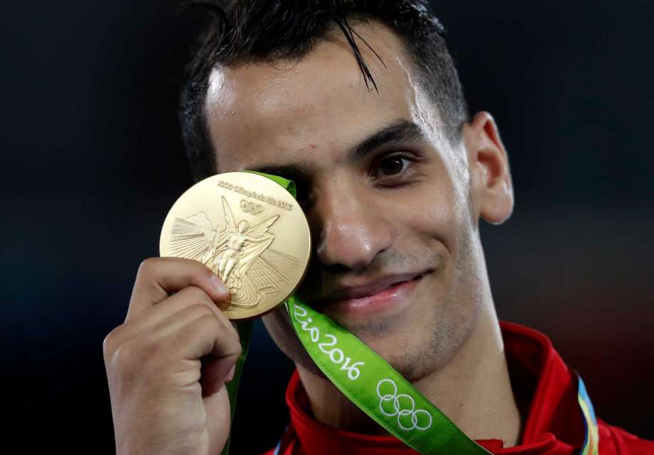 Ahmad Abughaush of Jordan shows of his gold medal in the men's 68-kg taekwondo competition at the 2016 Summer Olympics in Rio de Janeiro Brazil Thursday Aug. 18 2016. Abughaush won the gold