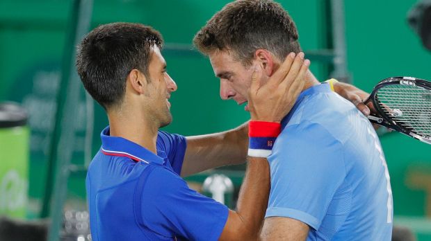 Juan Martin del Potro cries while hugging Novak Djokovic