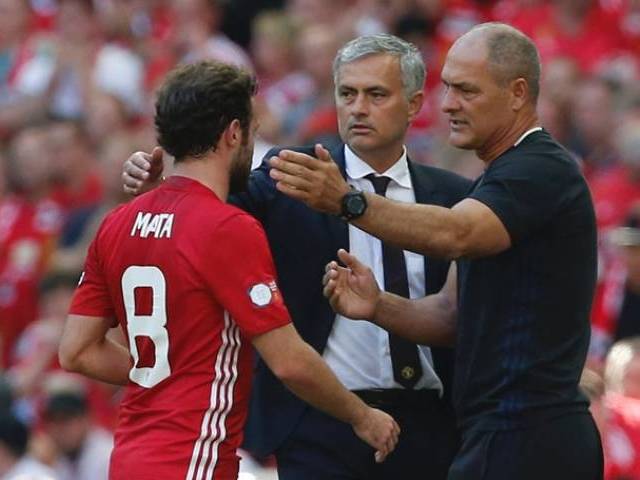 Juan Mata is greeted by manager Jose Mourinho and first team coach Silvino Louro at Wembley Stadium in London