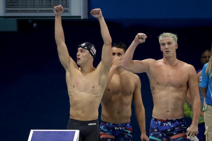 RIO DE JANEIRO BRAZIL- AUGUST 07 James Feigen Ryan Held and Blake Pieroni of the United States celebrate winning heat two of the Men's 4 x 100m Freestyle Relay on Day 2 of the Rio 2016 Olympic Games at the Olympic Aquatics Stadium