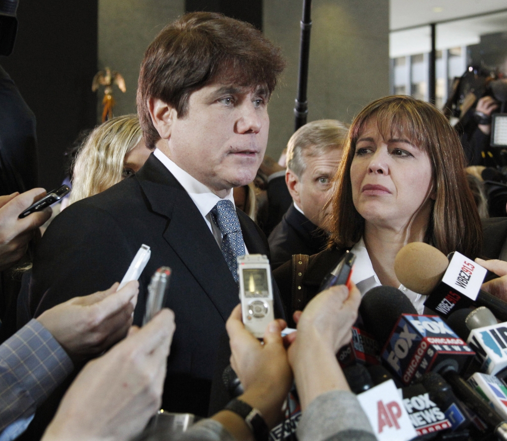 Former Illinois Gov. Rod Blagojevich left with his wife Patti speaks to reporters in December 2011 at the federal building in Chicago after Blagojevich was sentenced to 14 years on 18 corruption counts. But five of those have been tossed on appeal