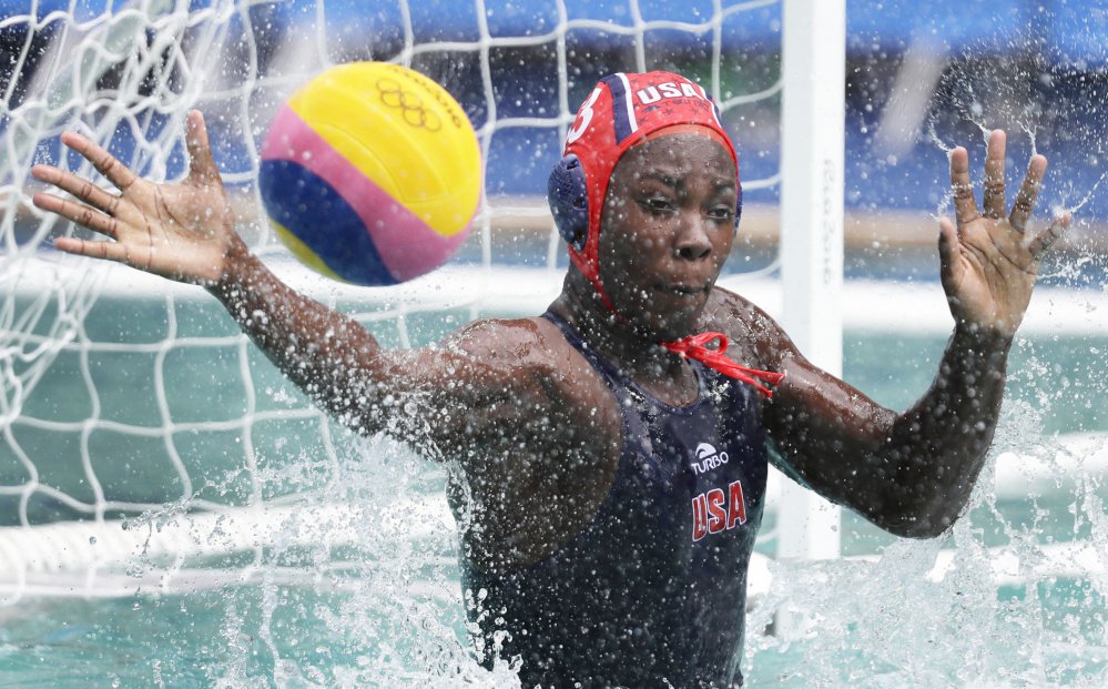 Ashleigh Johnson of the United States attempts to stop the ball Thursday during the 12-4 victory against China in women's water polo. Including the Olympics the U.S. has an 18-game winning streak