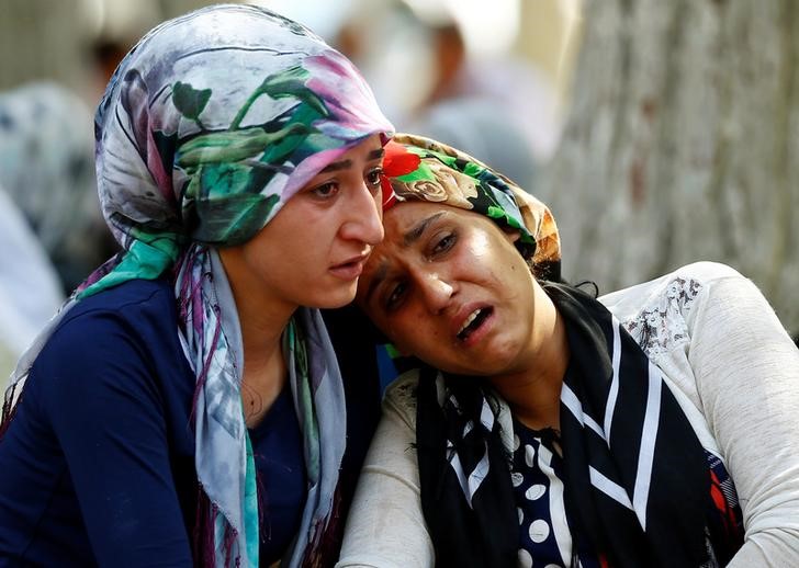 Women mourn as they wait in front of a hospital morgue in the Turkish city of Gaziantep after a suspected bomber targeted a wedding celebration in the city Turkey