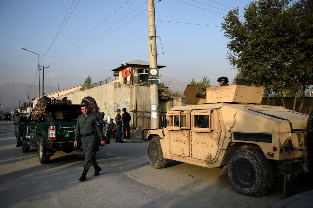 Afghan security personnel keep watch near the site following the militants raid that targeted the elite American University of Afghanistan in Kabul