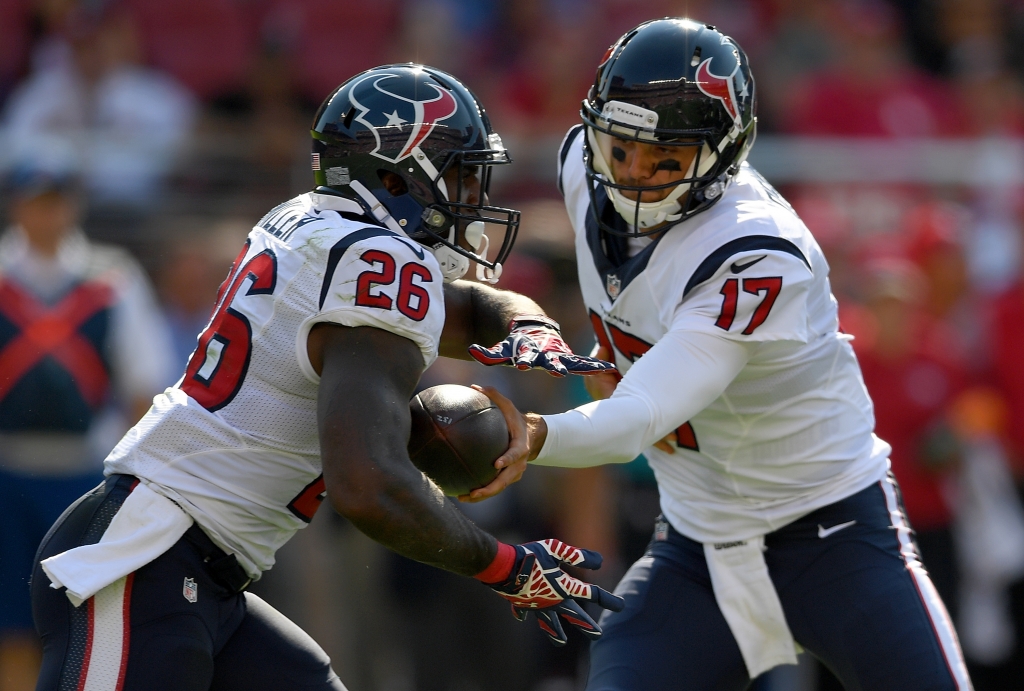 SANTA CLARA CA- AUGUST 14 Quarterback Brock Osweiler #17 of the Houston Texans hand the ball off to running back Lamar Miller #26 against the San Francisco 49ers in the first quarter of a preseason game at Levi's Stadium