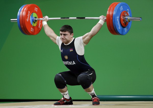 Andranik Karapetyan competes during the men's 77kg weightlifting in Rio