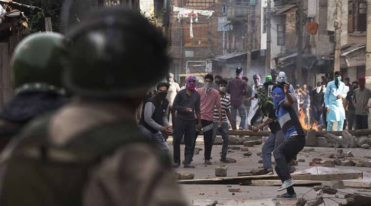 Kashmiri Protesters throw stones at security personnels during a protest in Srinagar on Tuesday