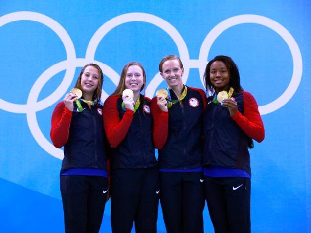 Gold medalists US Kathleen Baker Lilly King Dana Vollmer Simone Manuel celebrate on the podium during the medal ceremony for the Women's 4 x 100m medley relay final of the Rio 2016 Olympic Games at the Olympic Aquatics Stadium on Saturday