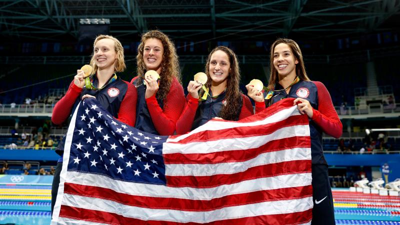 Gold medalists left to right Katie Ledecky Allison Schmitt Leah Smith and Maya Di Rado of the United States pose on the podium during the medal ceremony for the women's 4 x 200 meter freestyle relay final Wednesday