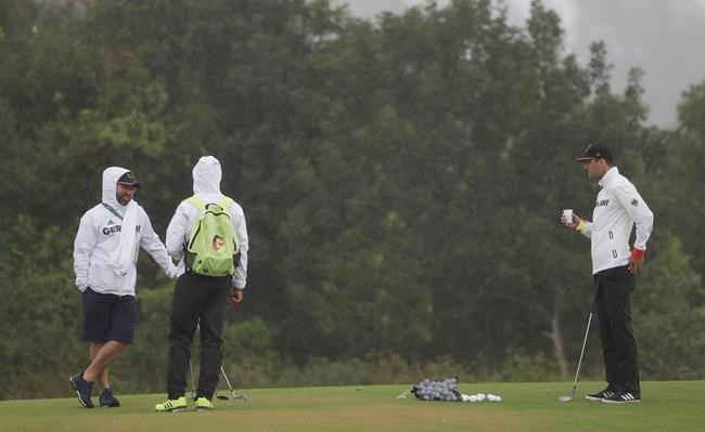 Martin Kaymer of Germany take a drink on the chipping green as he prepares for the men's golf event at the 2016 Summer Olympics in Rio de Janeiro Brazil Wednesday Aug. 10 2016