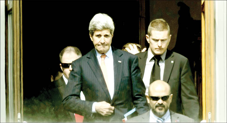 U.S. Secretary of State John Kerry center walks outside the hotel during a break from a bilateral meeting with Iranian Foreign Minister Mohammad Javad Zarif for a new round of Nuclear Talks in Lausanne Switzerland on Thursday March 19. (AP