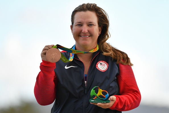 Bronze medal winner US Kimberly Rhode celebrates on the podium during the medal ceremony for the Skeet Women's Finals shooting event at the Rio 2016 Olympic Games at the Olympic Shooting Centre in Rio de Janeiro