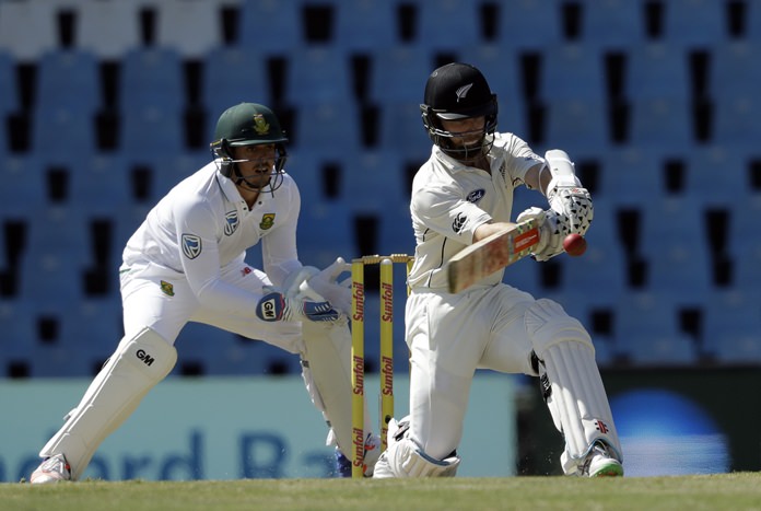 New Zealand's captain Kane Williamson right plays a shot as South Africa's wicketkeeper Quinton de Kock watches during the third day of their second cricket test match at Centurion Park in Pretoria South Africa Monday Aug. 29. (AP